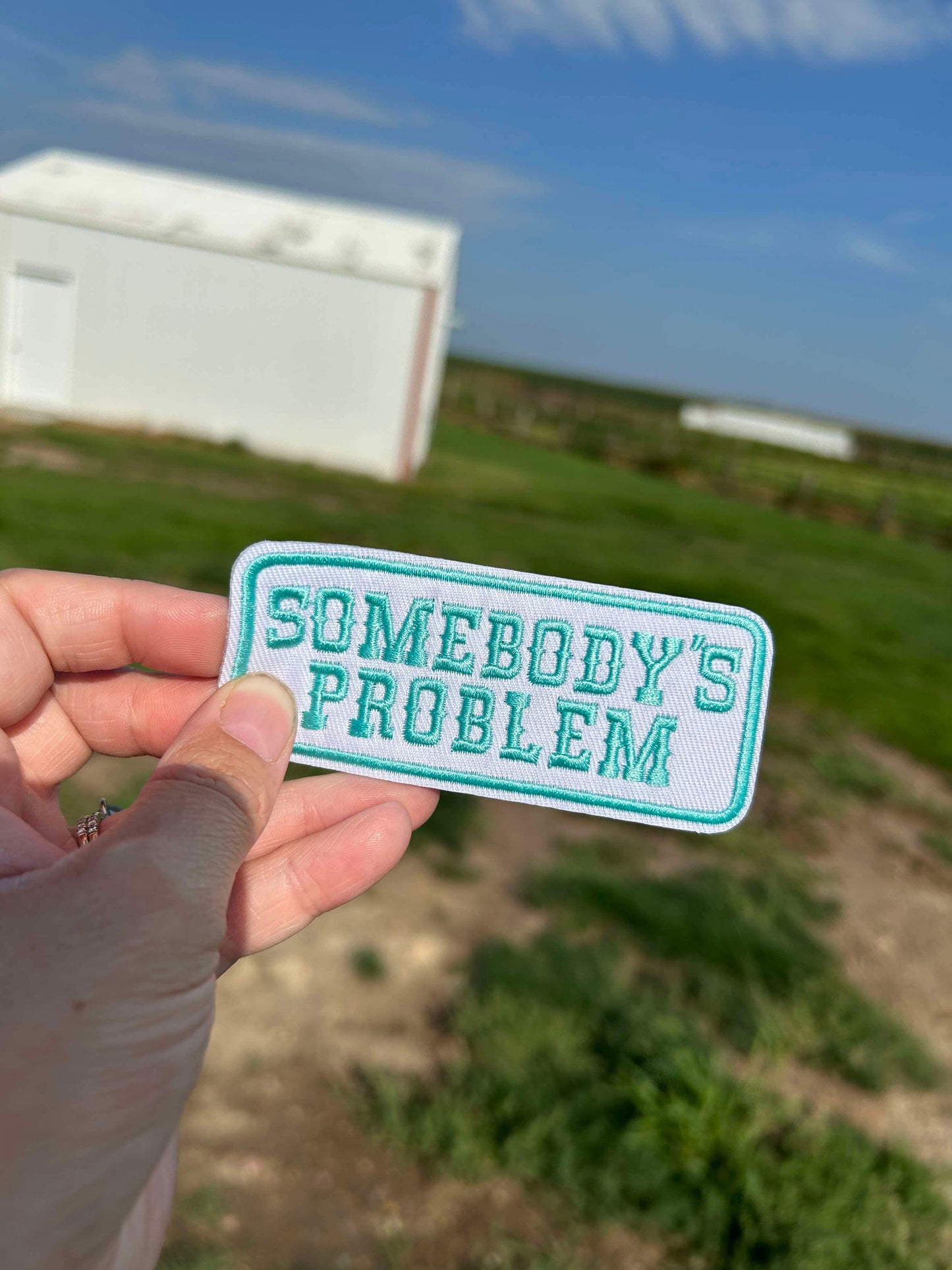 Teal Somebodys Problem Hat Patch